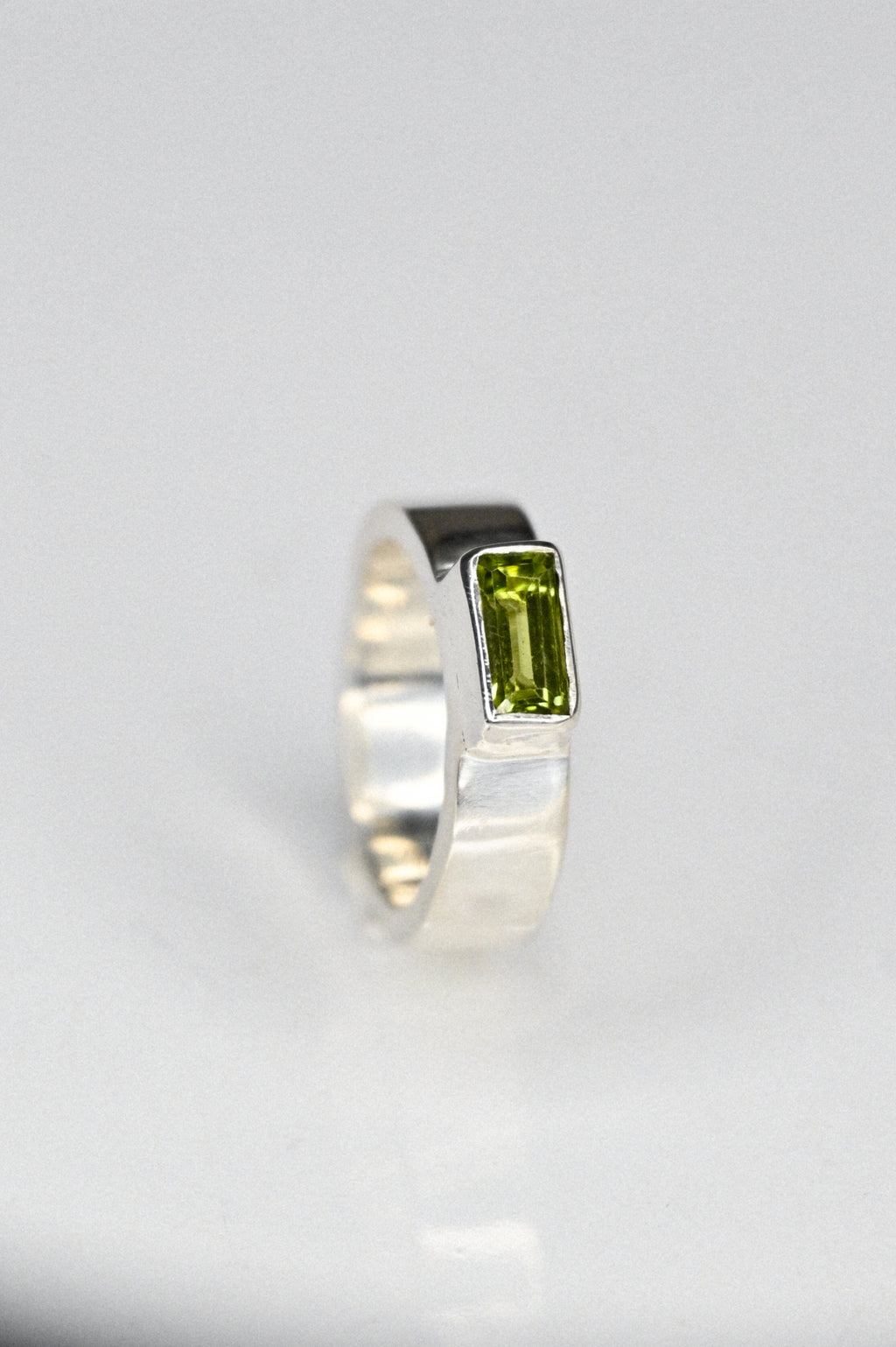 the one with a green peridot